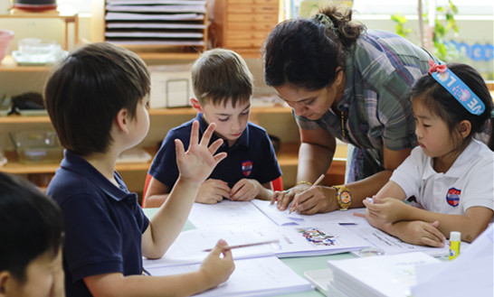 Students engaged in focused learning, showcasing the academic excellence promoted at Qingdao Amerasia International School (QAIS), an accredited IB World School in Qingdao.