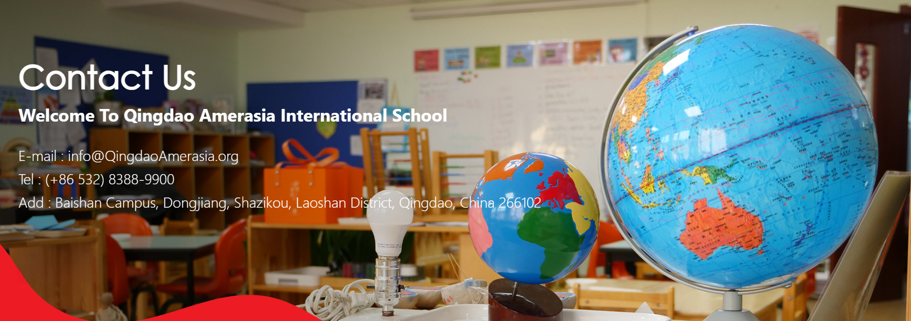 Classroom scene at Qingdao International School featuring colorful globes and educational tools, highlighting global education and contact info at QAIS.