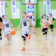 Students from Qingdao International School competing in a girls’ basketball game, highlighting the athletic programs and team spirit at Qingdao Amerasia International School.