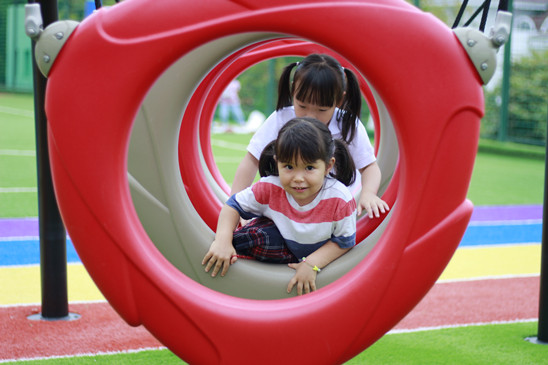 Supportive interaction between students at Qingdao Amerasia International School (QAIS), highlighting the focus on community well-being and child protection at this Qingdao international school.